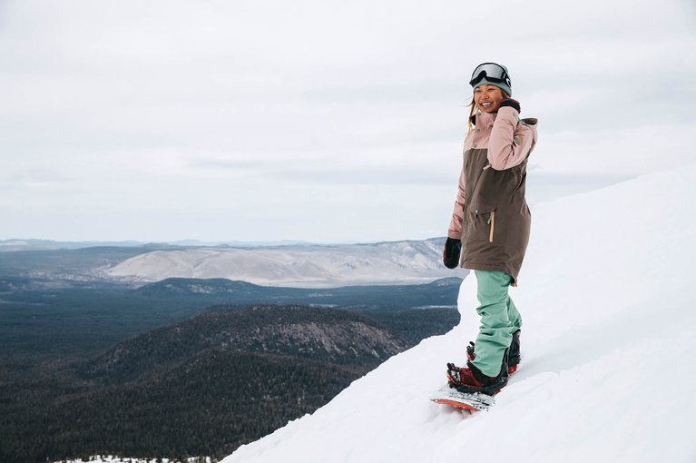 Chloe Kim strapped into her board on snow