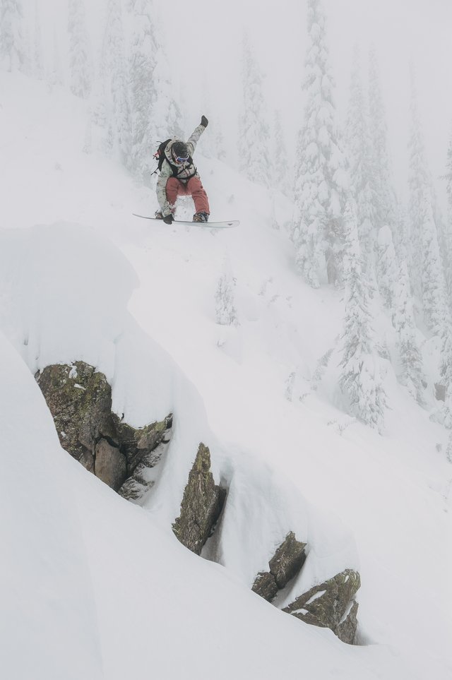 Kelly Clark dropping a cliff in the backcountry.