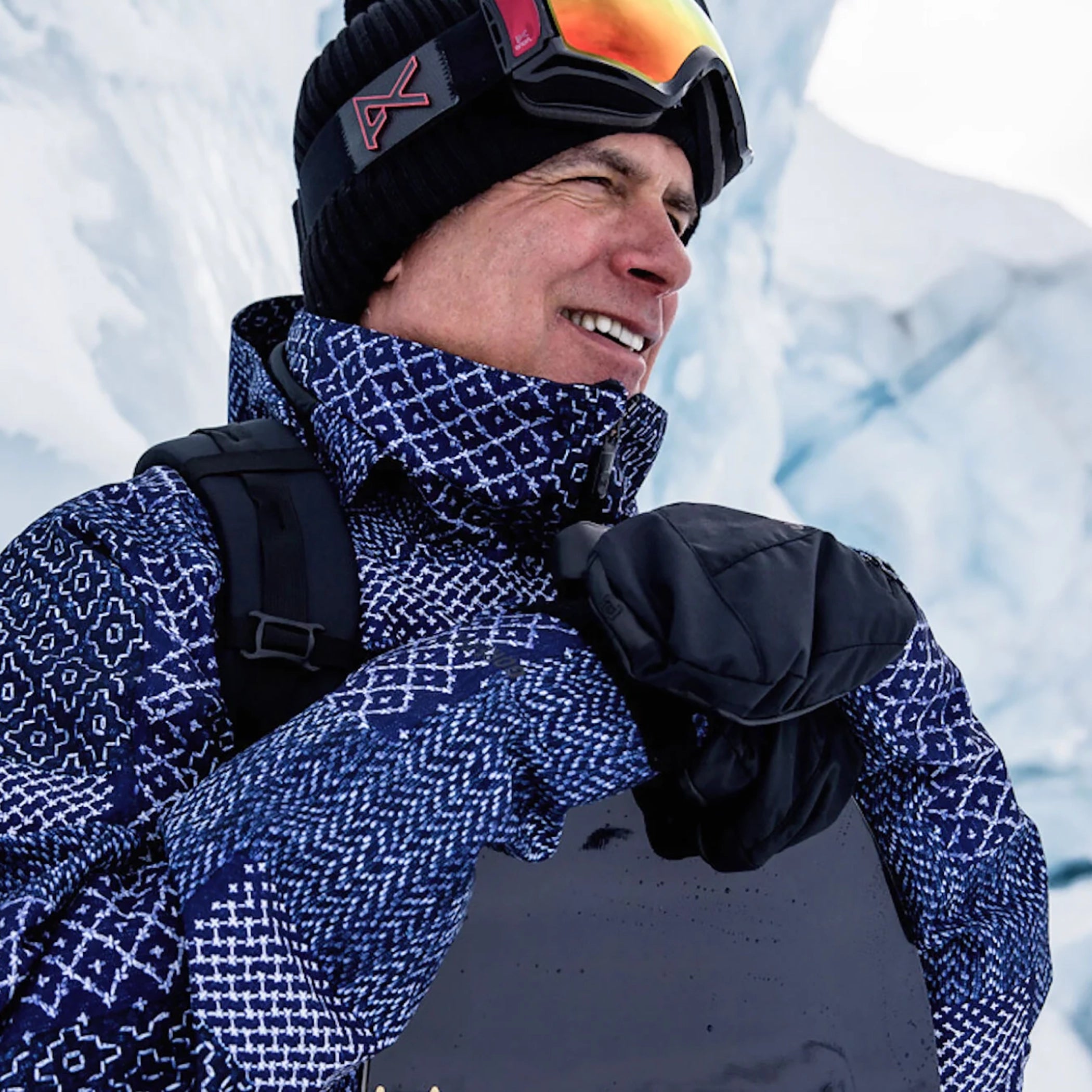 Person wearing winter gear with a snowy background
