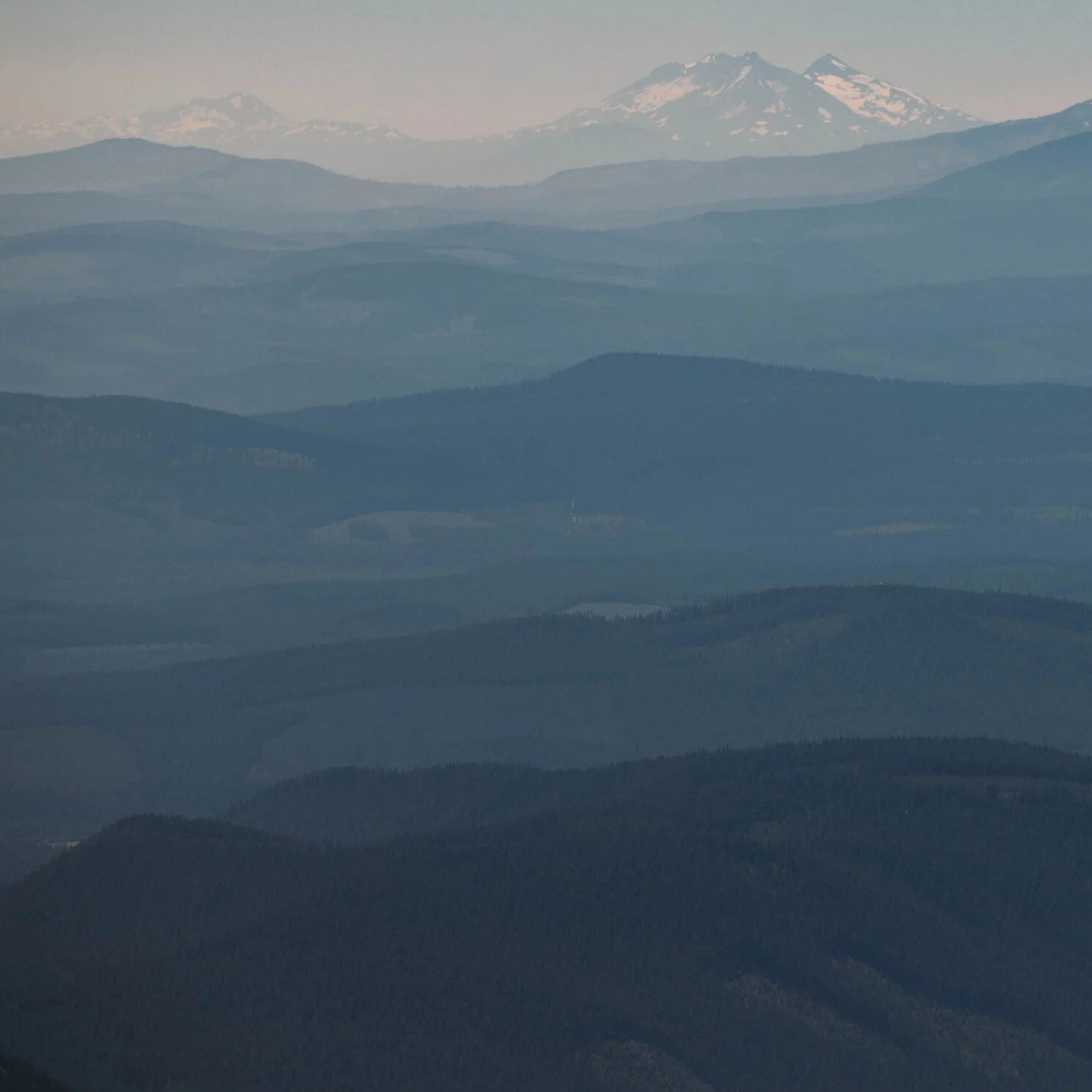 Hazy mountain range with a prominent peak in the distance