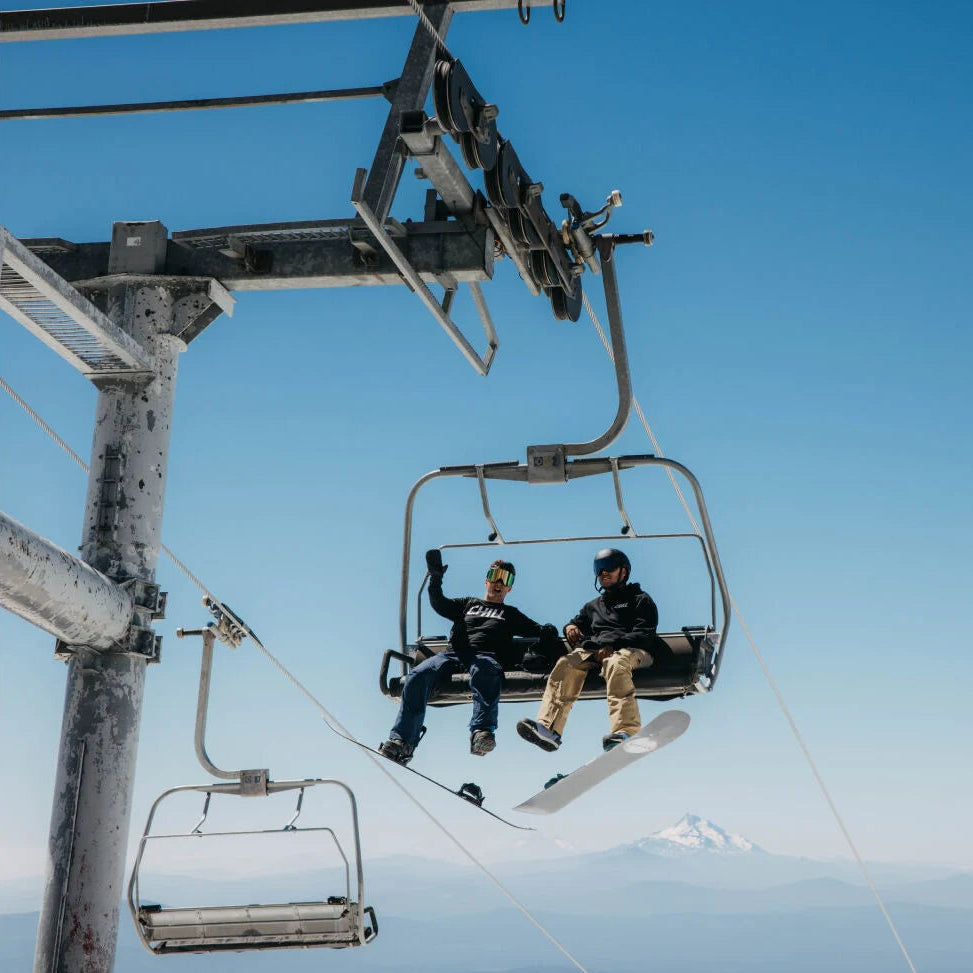 Two riders on a chair lift