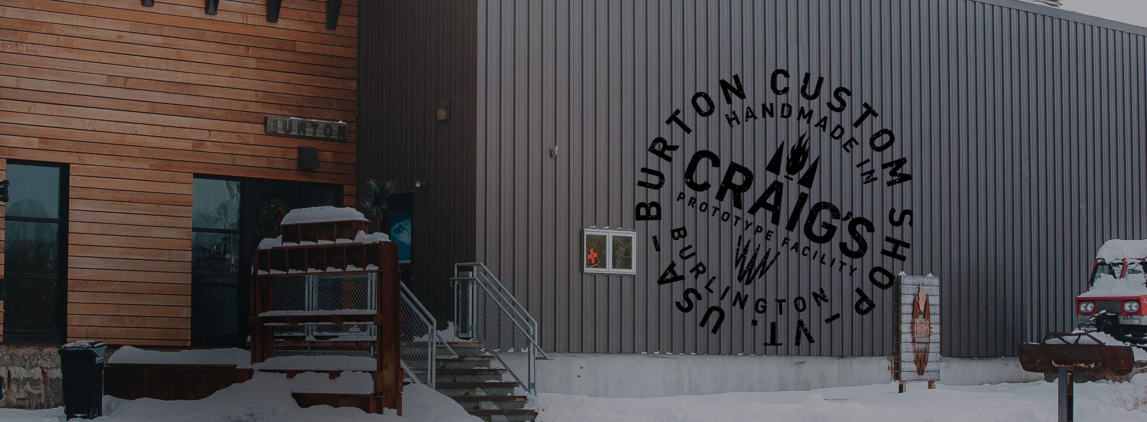 Building exterior with 'Burton Custom Handmade' logo on a snowy day