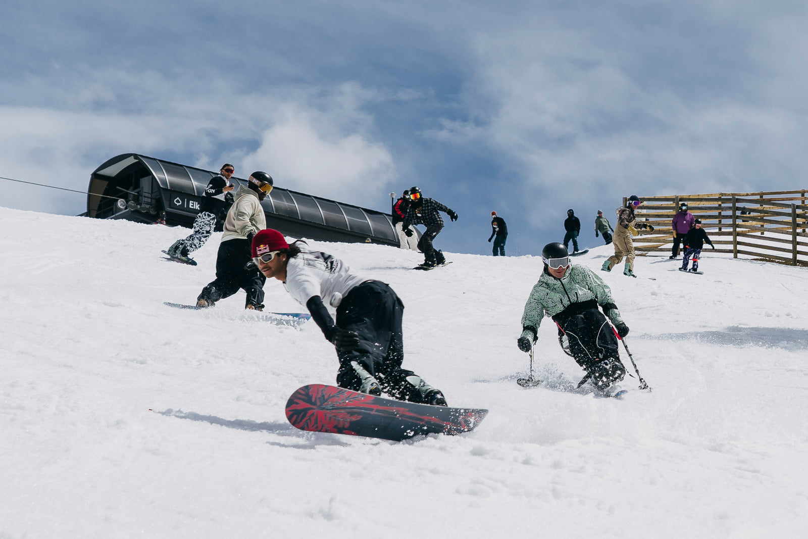 Snowboarders taking a party lap