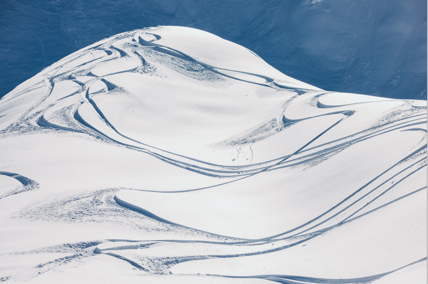 Snowy mountain landscape with snowboard tracks