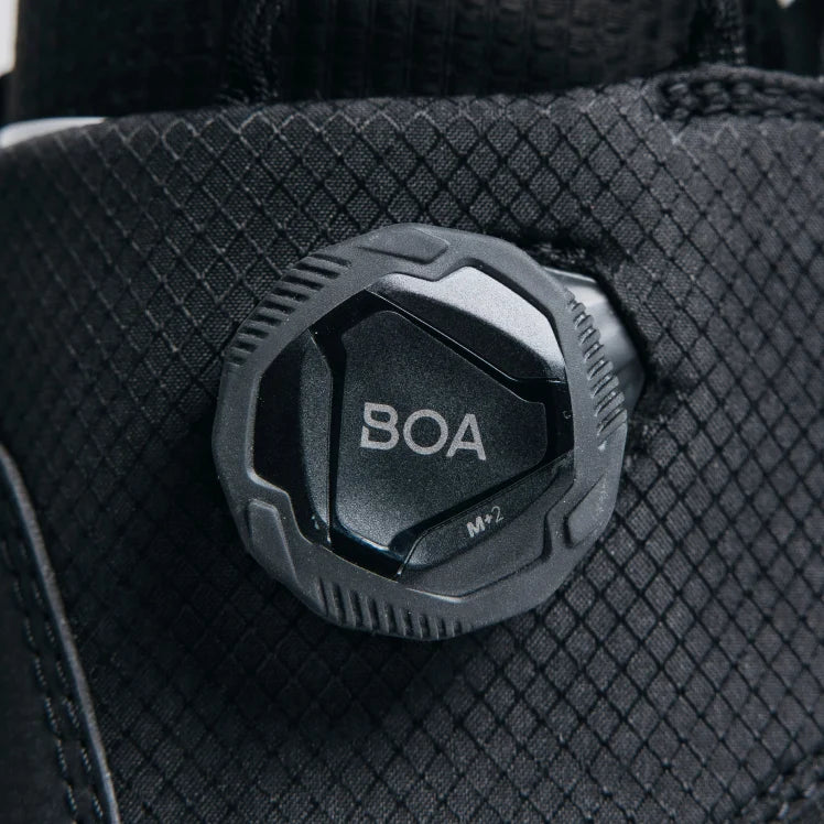 Close-up of a BOA system knob on a black boot