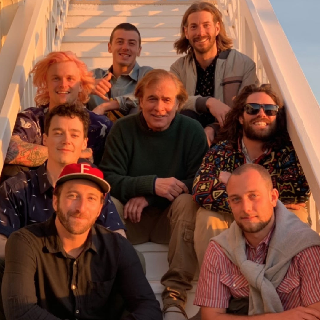 Jake Burton Carpenter poses with Burton Team riders during Rider Round Table