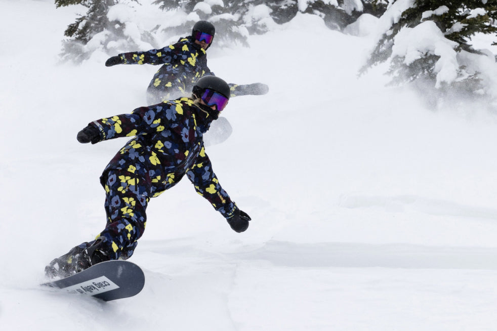 People ride powder in matching outerwear from the 2022 Mine77 Deep Winter Collection
