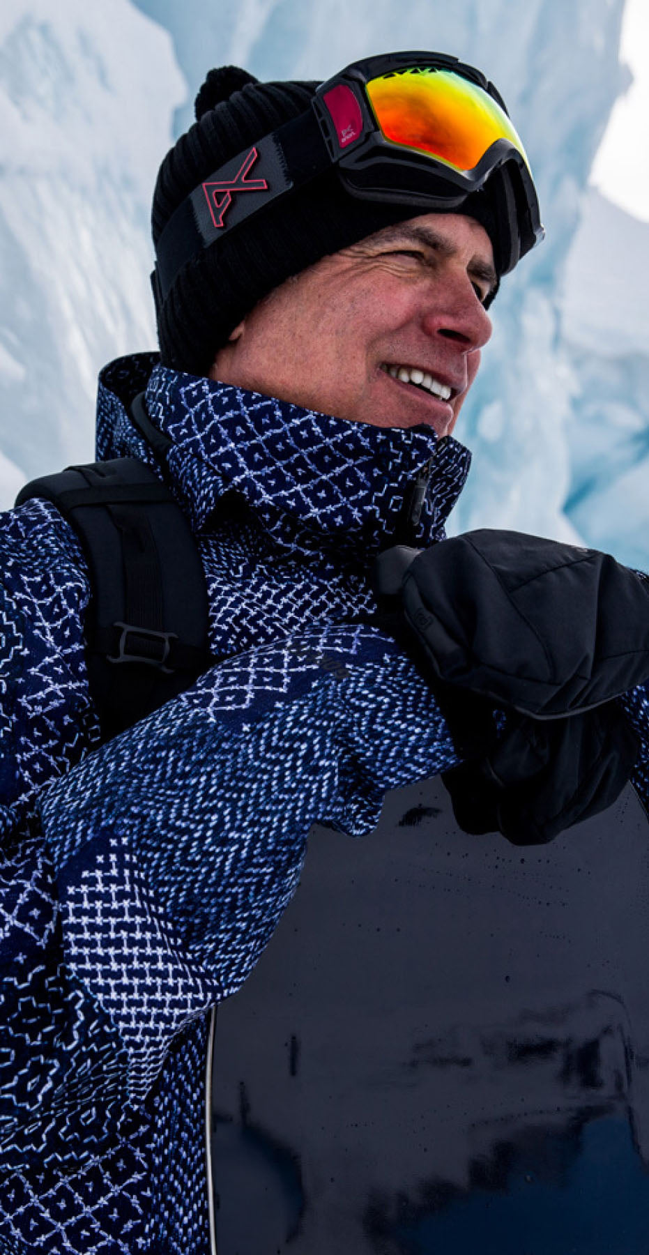 Jake Burton Carpenter on mountain holding a Burton snowboard