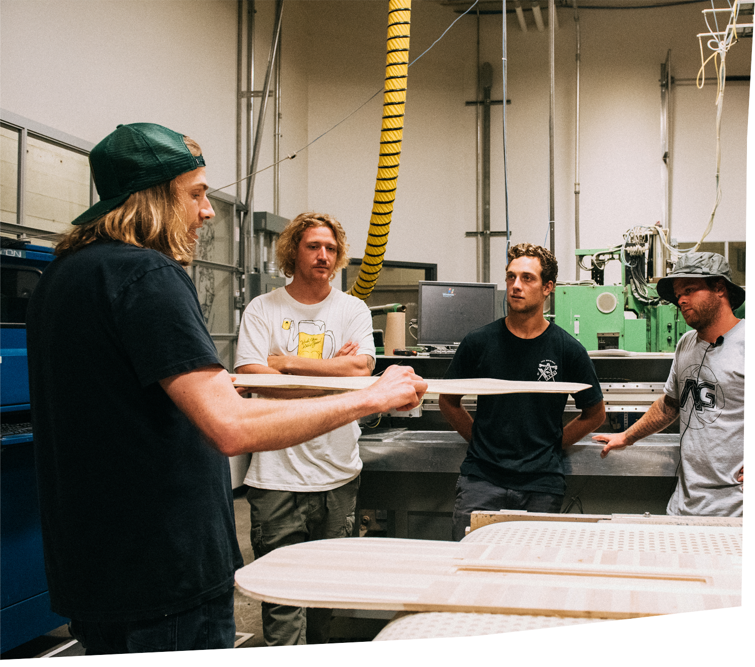 TK showing Burton Team Riders a snowboard core on the Burton Headquarters Tour.